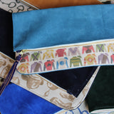 pierce pouch | licorice suede | running horses